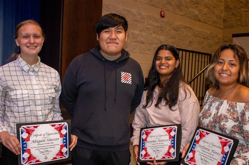 A student is honored for serving in the US Armed Forces after high school